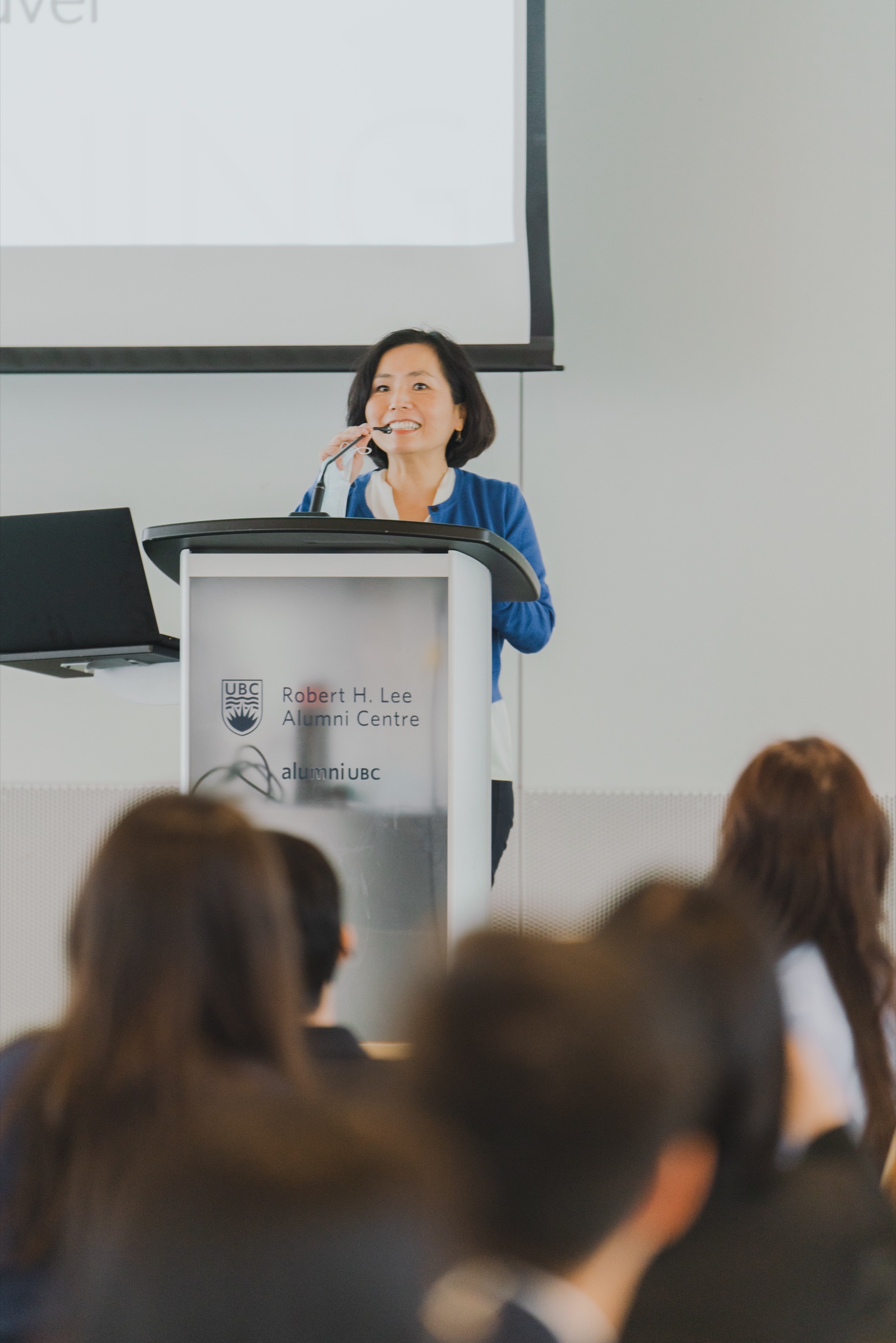 A keynote speaker addressing guests from a podium