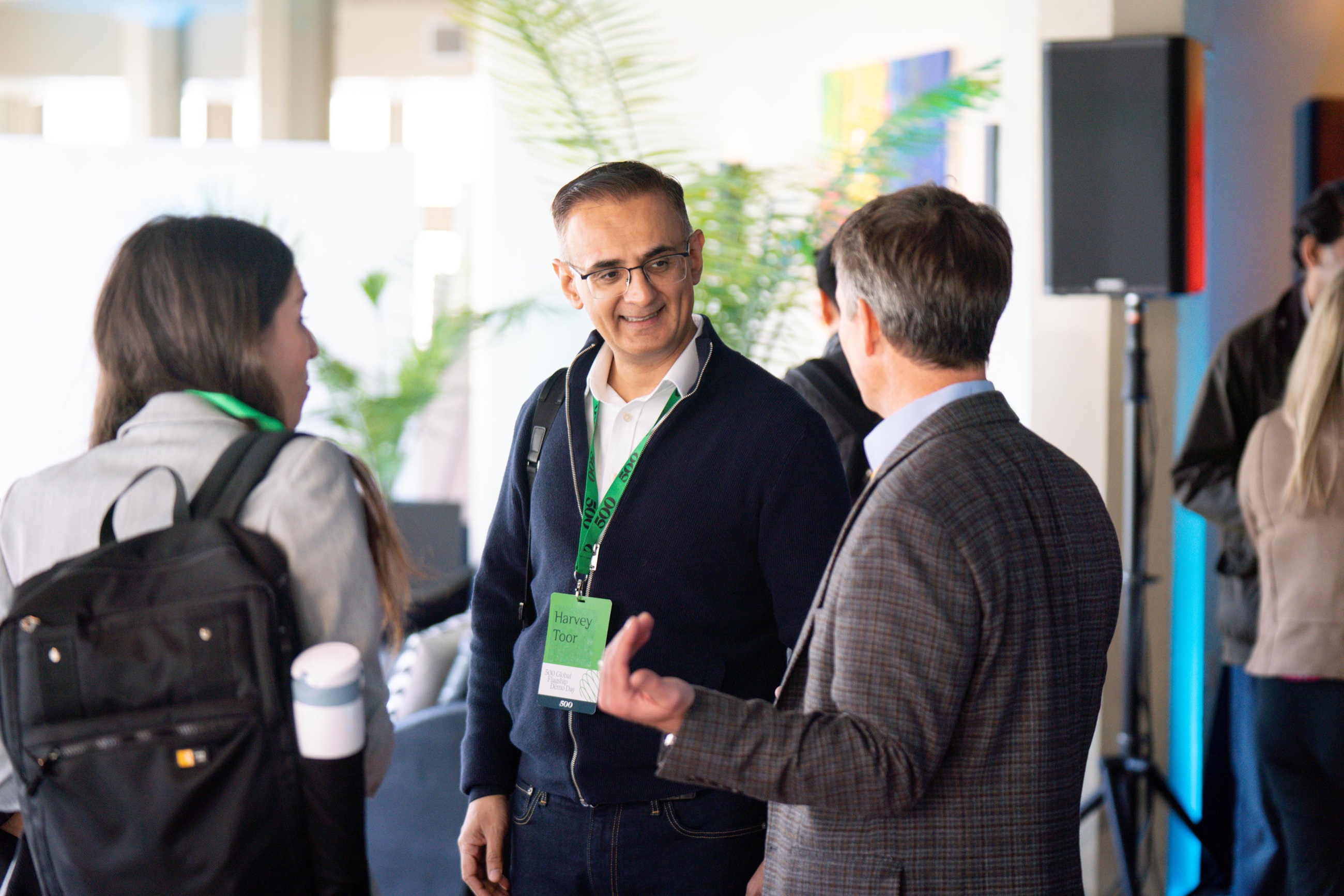 Three attendees sharing a conversation