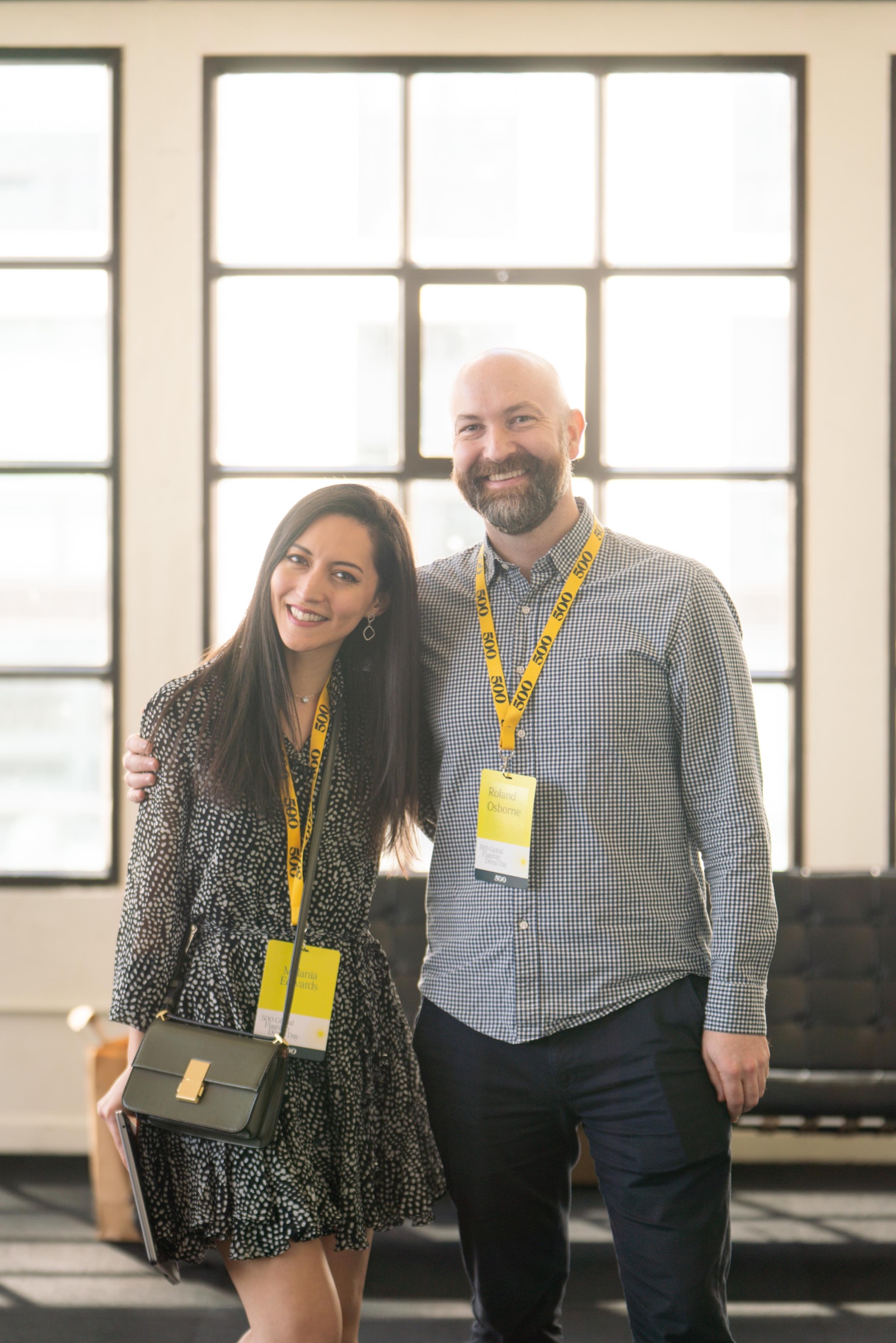 Two attendees smiling together at a corporate event