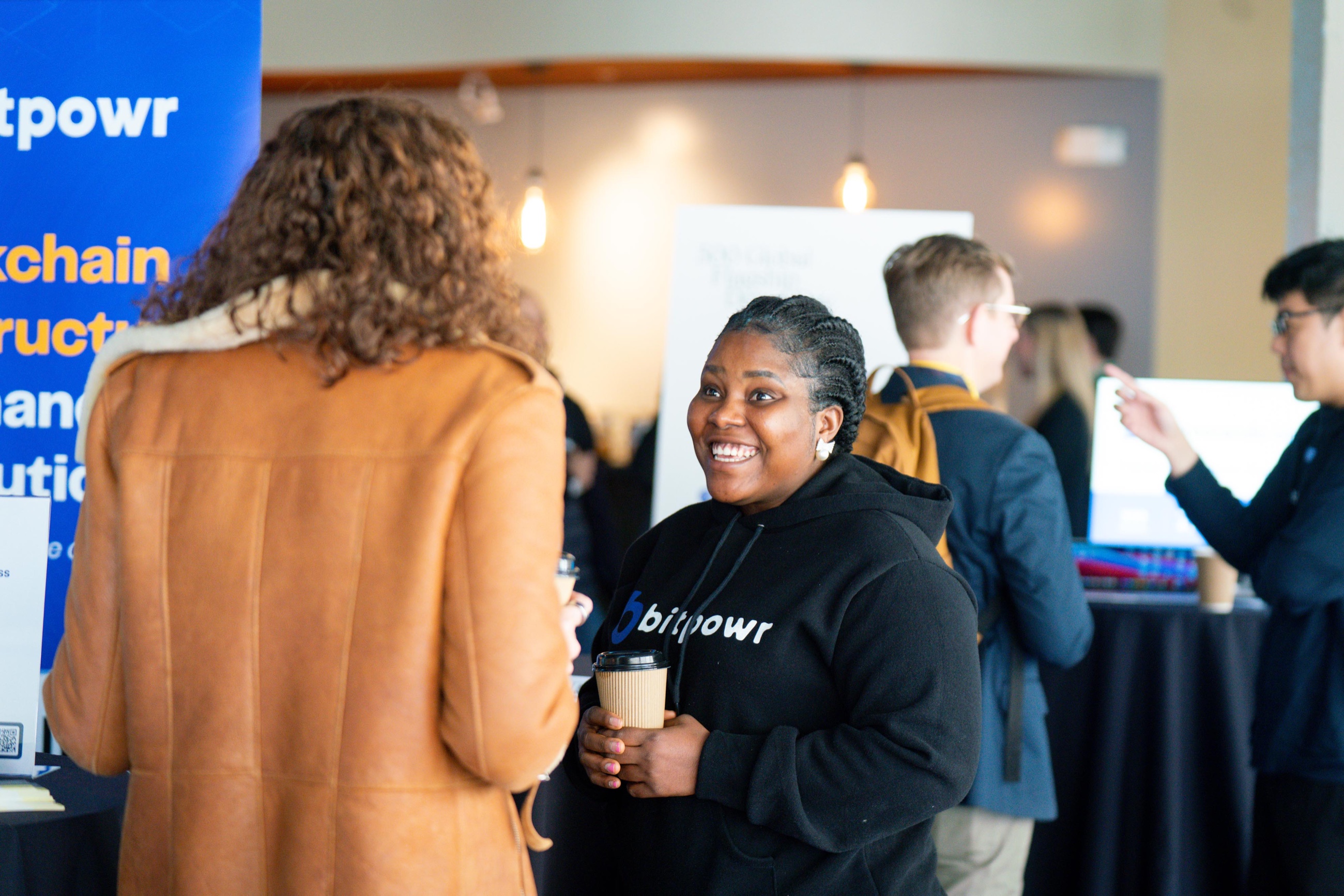 Guests connecting beside exhibitor booths