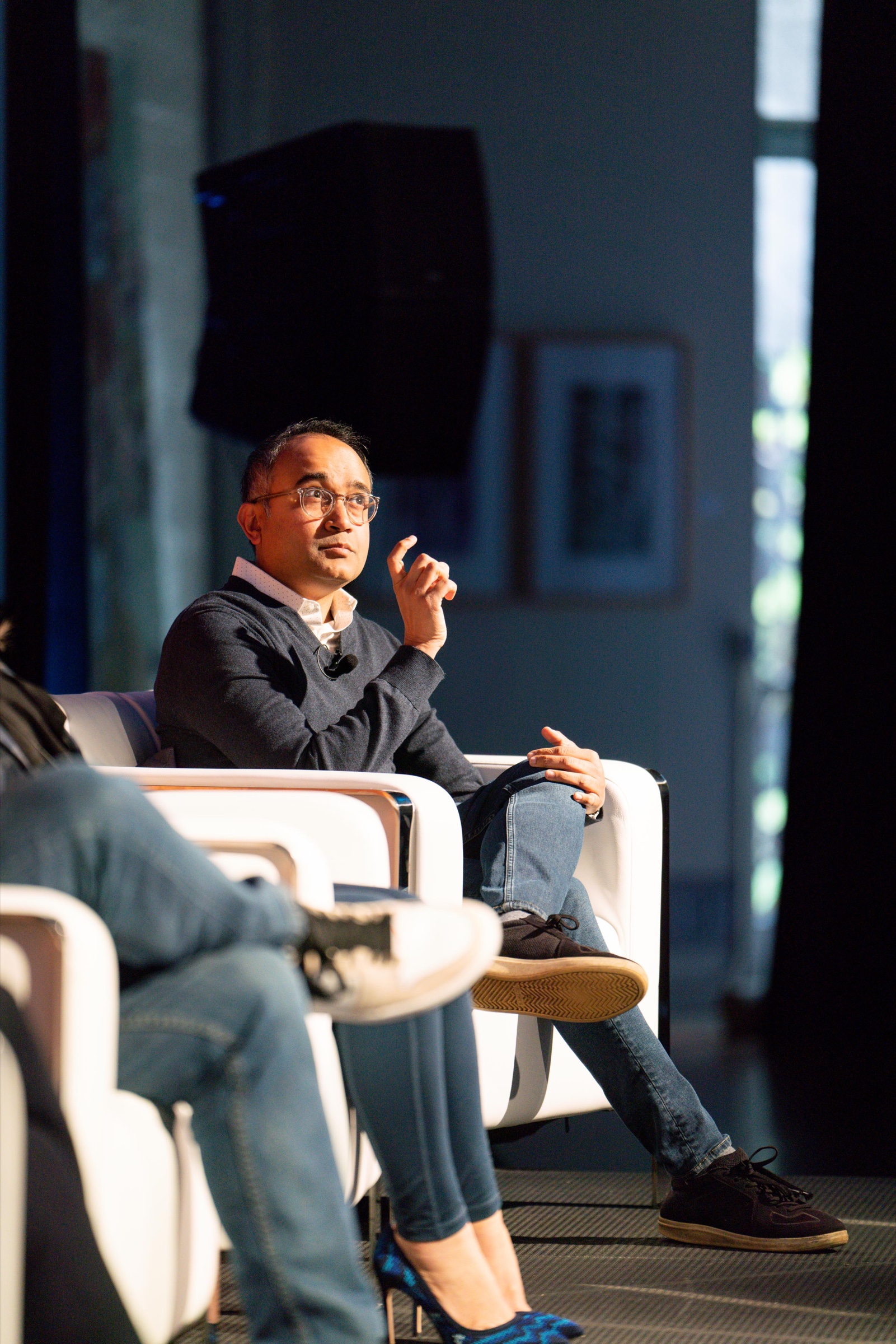 A conference panellist speaking onstage