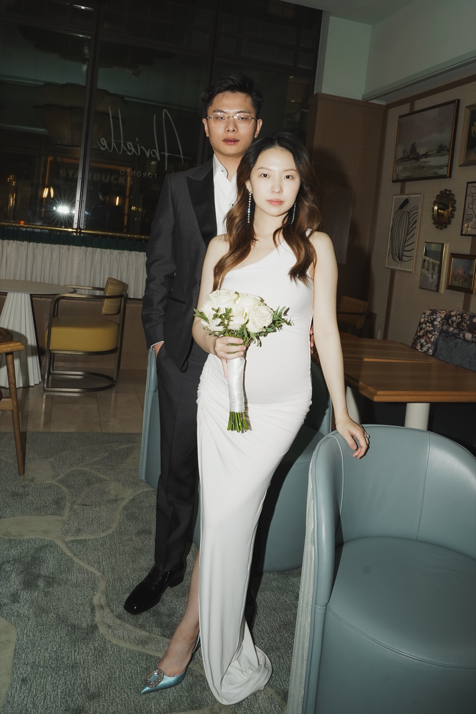 Newlyweds posing together in an intimate hotel lounge