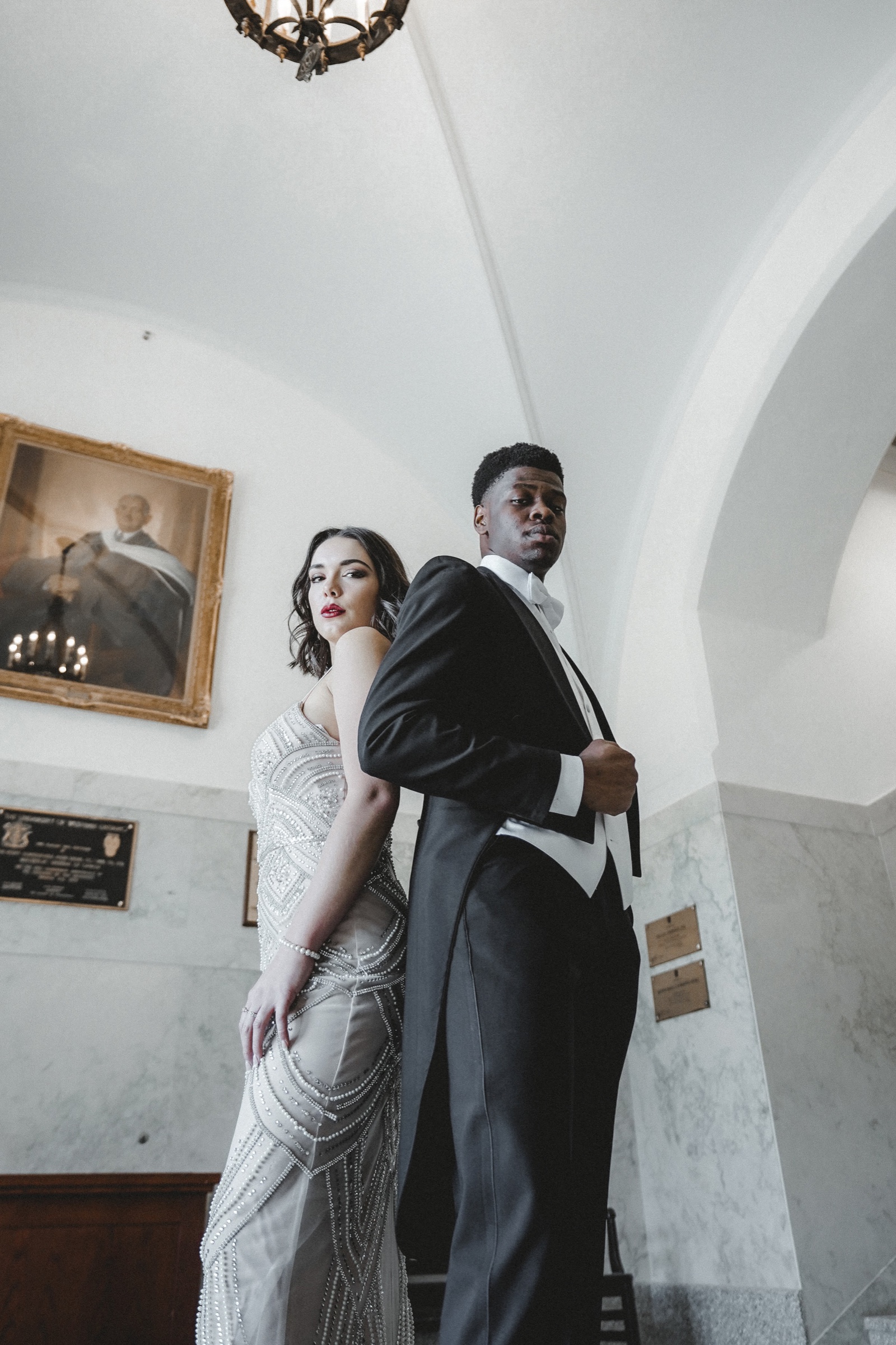 An editorial wedding portrait in a marble hall