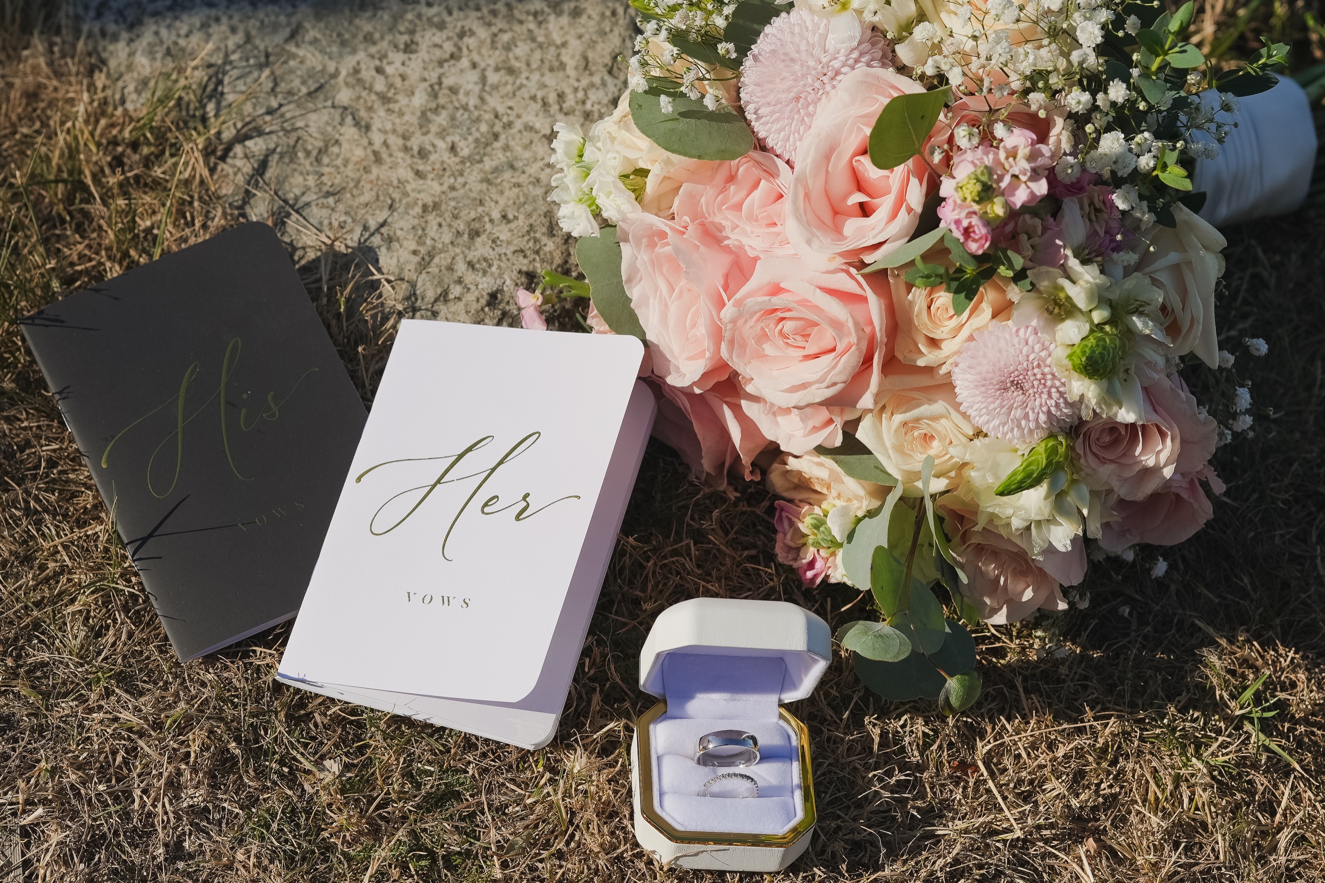 Wedding vows, rings, and a pastel floral bouquet