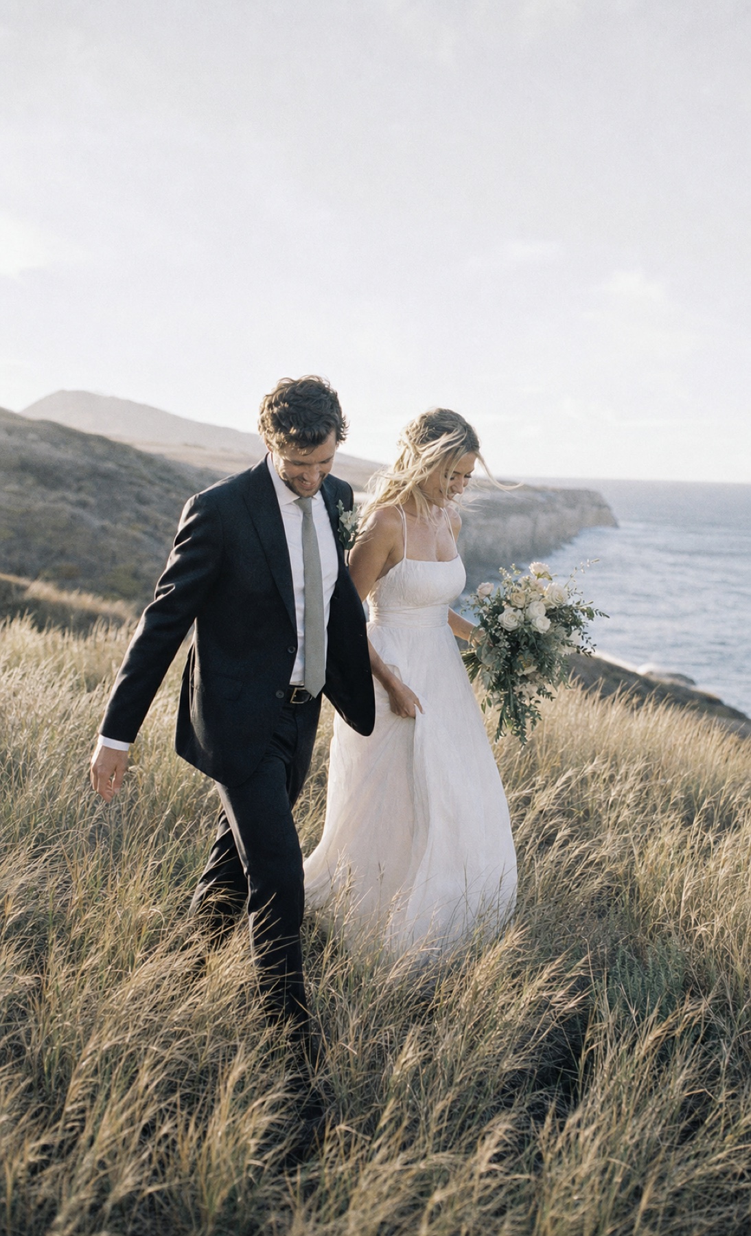 Couple walking together in soft coastal light